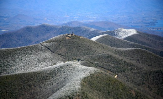 Photo of Brasstown Bald in winters. Mountains surrounding Brasstown Bald covered in snow with Visitor center and firetower as focal point.