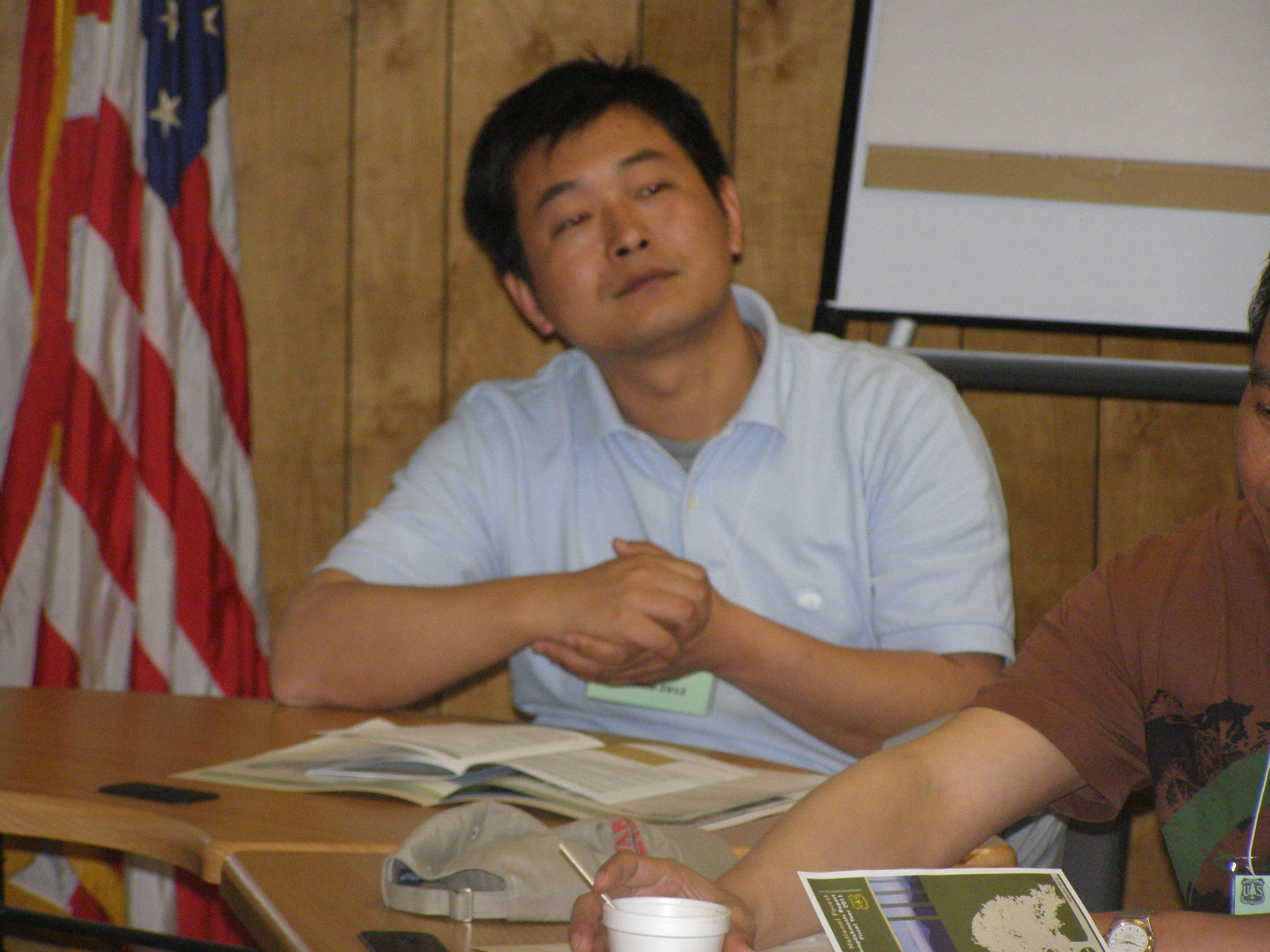 Interpreter Fei Zhang speaks during the Chinese delegation visit.