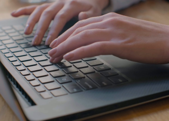 Hands typing on a keyboard