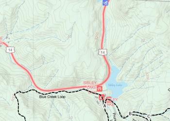 An image of a map with a road and lake