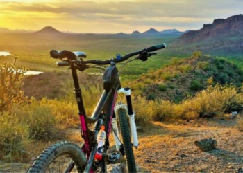 mountain bike on an elevated path during a colorful sunset
