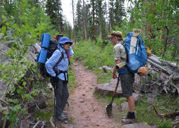 Three people in a trail
