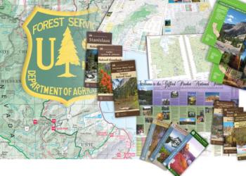 Forest Service insignia with various map products around it.