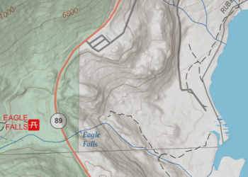 Topo Map showing lines indicating elevation of topography near a highway and lake.