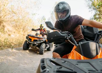 People on orange ATVs