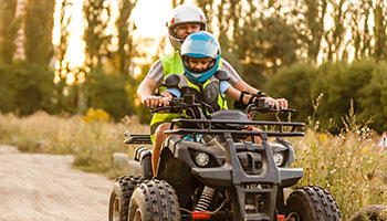 Two OHV riders on a trail.