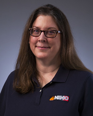 Photo of a woman in a navy blue shirt with a NIMO logo