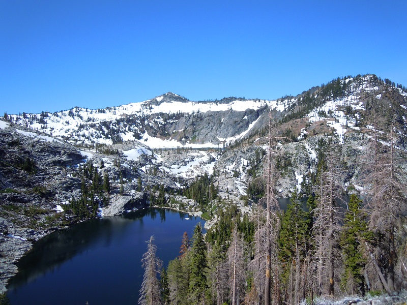 This photograph shows a lake within granite peaks typical in the Trinity Alps Wilderness Area.