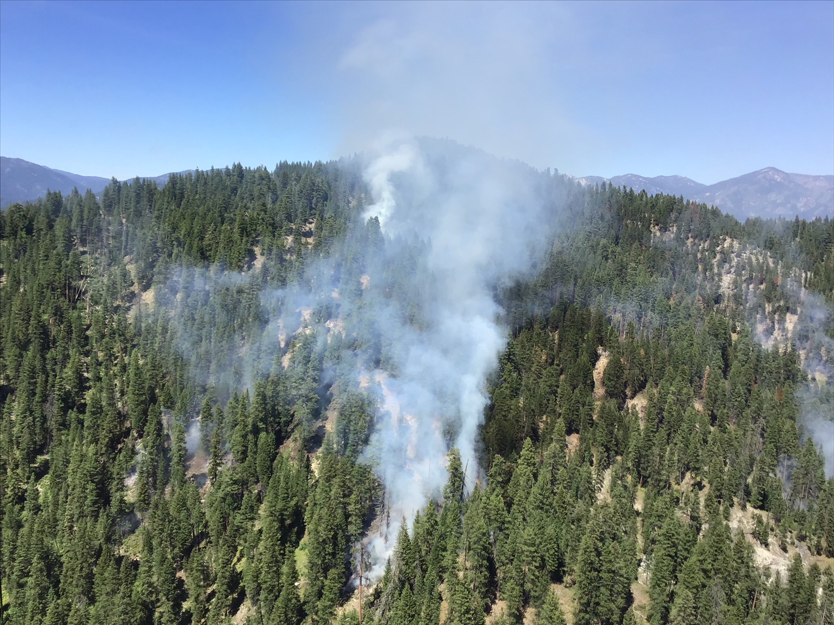 photo of smoke and fire moving north on slope