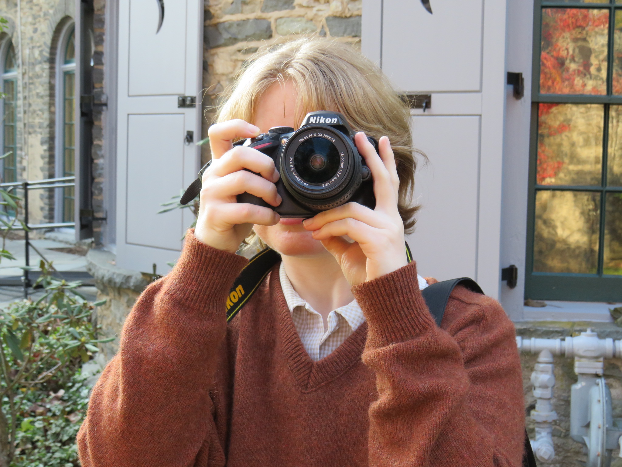 photographer with camera covering their face