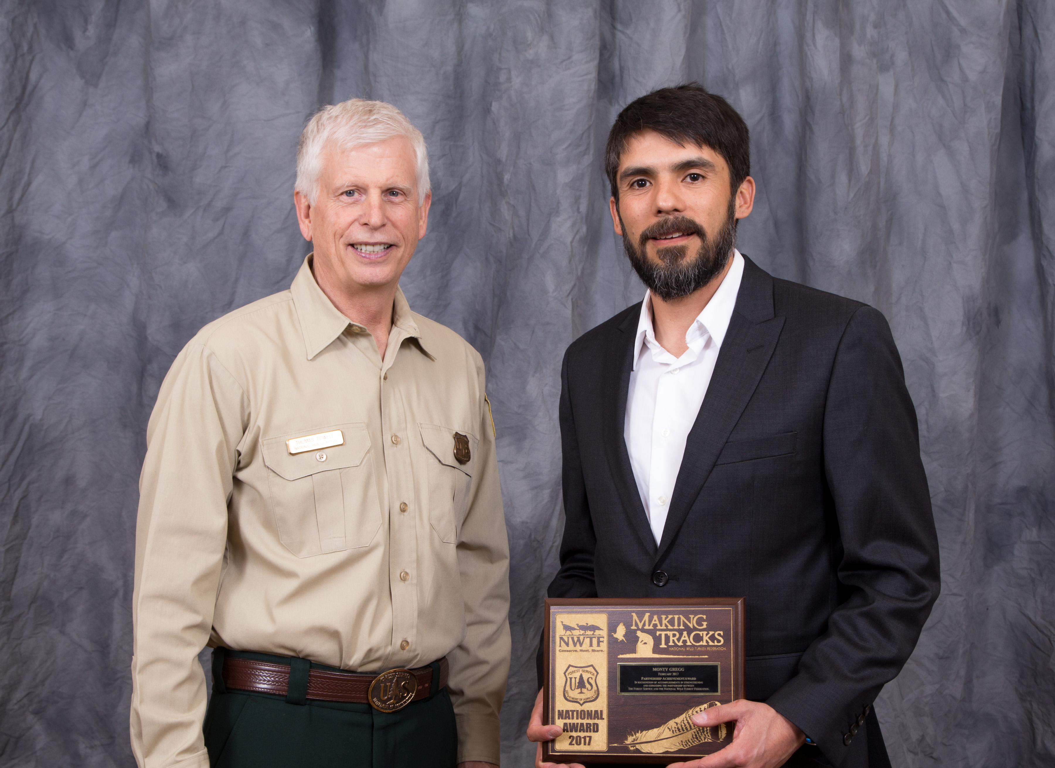 Photograph of Monty Gregg (on right) with Chief Tidwell accepting the award.
