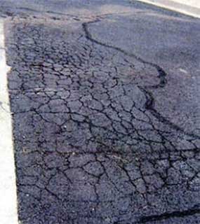 Photo of severely cracked asphalt.
