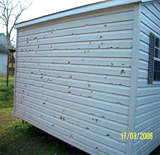 Photo of damaged wood siding.