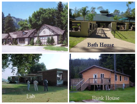 Photo of four buildings.  Three are labelled with Bath House, Bunk House, and Lab.  The fourth is large and looks like an office.