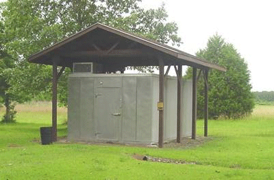 Photo of a covered structure with no walls and a seedling cooler under the canopy.