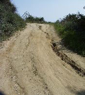 Gully formation on traveled way due to concentrated surface flow. 3