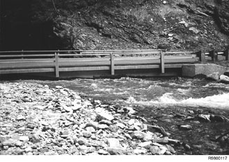 Figure 11Eagle Creek Bridge, Idaho Panhandle National Forest.  Backwater effects from the main river caused aggradation at the mouth of this tributary and inadequate clearance for the bridge.  Note, the following year the tributary flushed and the stream re-established the normal channel depth.