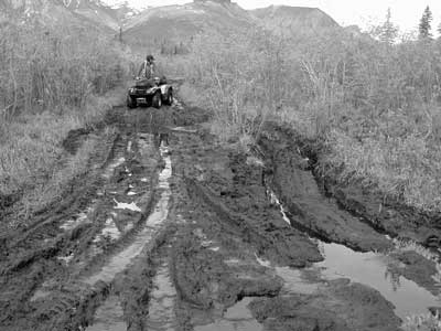 Photo of an ATV user on a degraded trail.