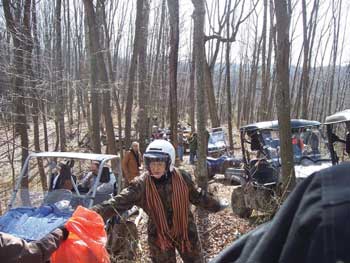 Photo of an ATV club picking up trash along an ATV forest trail.