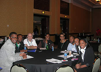 New hires sitted at a table at the SAF Convention Student Orientation and Reception.