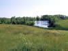 Picture of a pond surrounded by small trees.