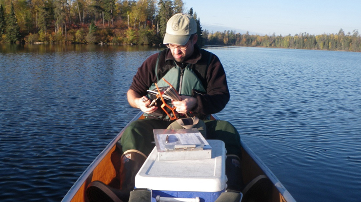 Trent Wickman of the Superior National Forest water sampling for mercury analysis. Photo by Superior National Forest, USDA Forest Service