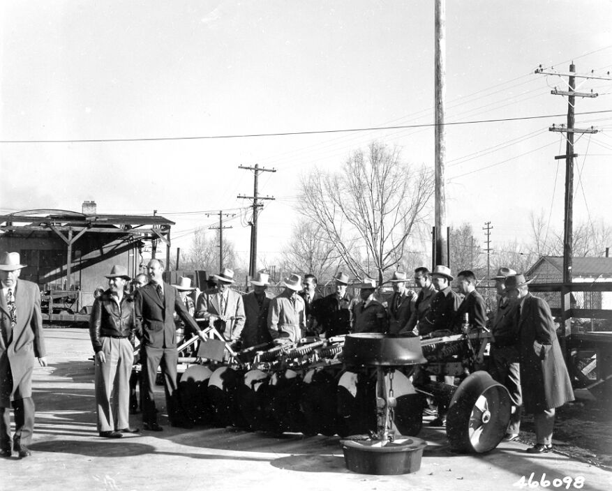 Toiyabe National Forest warehouse yard in Reno, Nevada. Members of Tri-State Reseeding Conference study the outstanding features of the Forest Service Brushland plow.