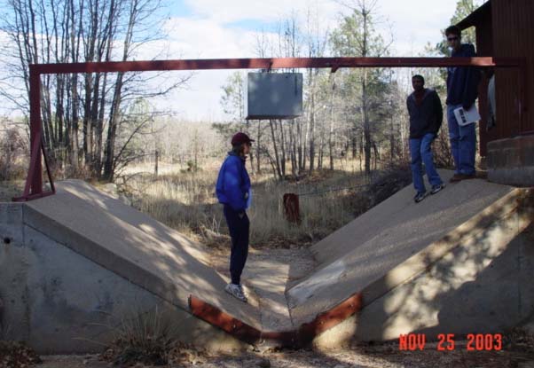 Students from NAU's School of Forestry are visiting the Watershed 12 gaging station during a field-trip for a Hydrology Course