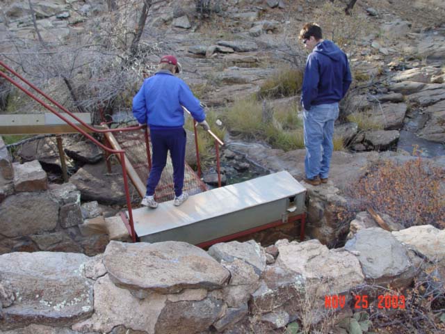Students from NAU's School of Forestry are inspecting Watershed 12's sedimentation collection instrumentation during a field-trip for a Hydrology Course.