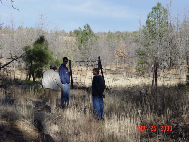 Hydrology Professor Aregai Tecle teaches students from NAU's School of Forestry about the history of Watershed 12during a field-trip for a Hydrology Course.