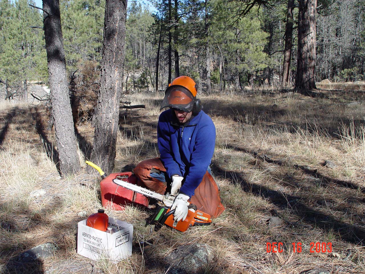 Duncan is tightening the chain of the saw during maintanence work at BarM Weather Station