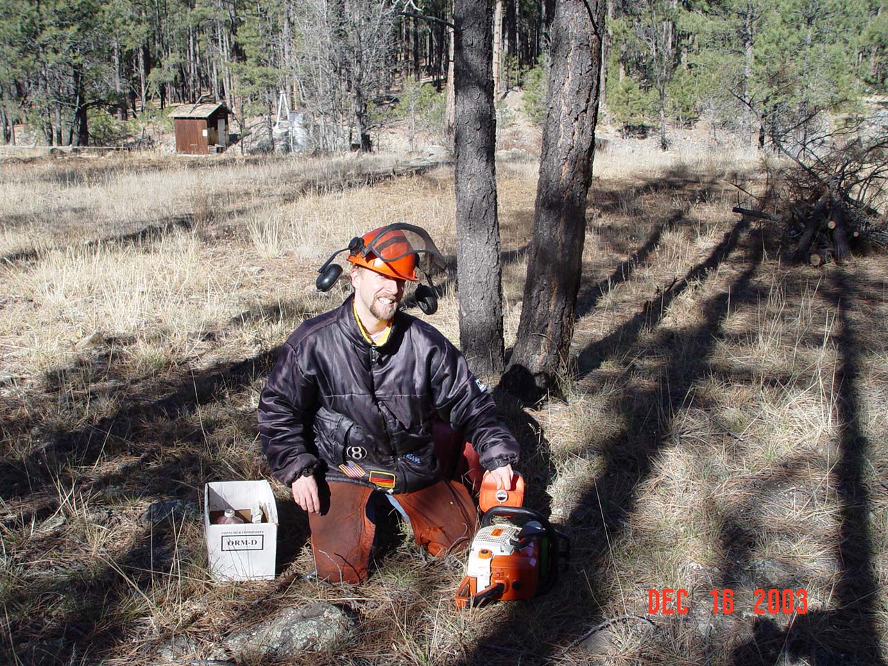 Boris is refilling the bar oil of a chain saw during maintanence work at BarM gaging station (seen in the back).