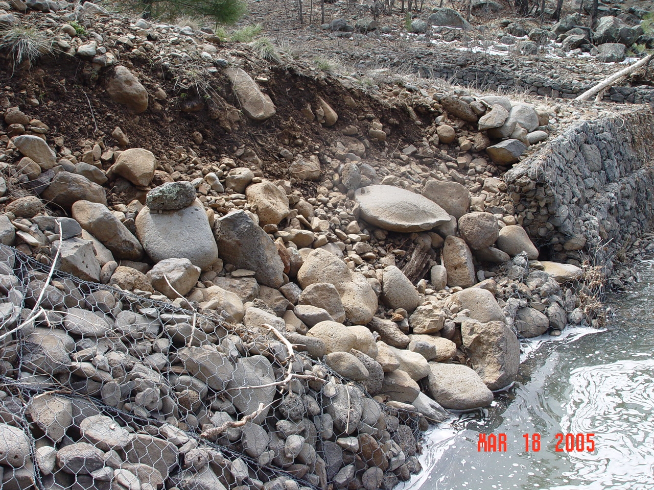 A more detail picture of the collapsed sidewall of the Bar M stilling pond that was damaged in high flow events in the winter of 2004/2005.
