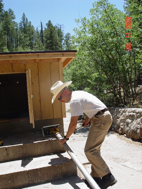Hydrologist Boris Poff is adding a solar panel to the streamgauging station of Watershed 9. 