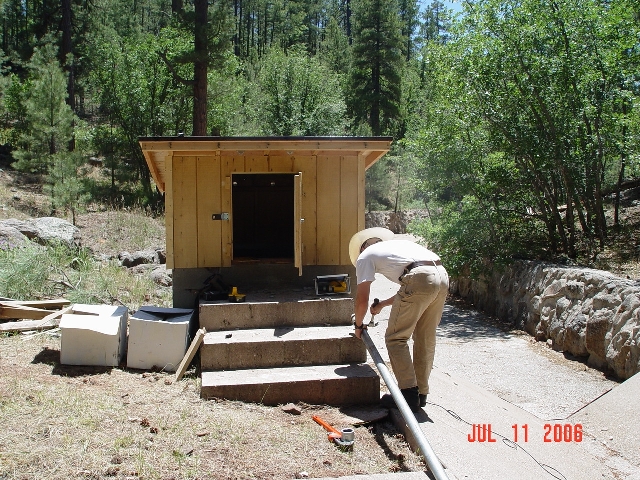 Hydrologist Boris Poff is adding a solar panel to the streamgauging station of Watershed 9. 