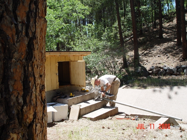 Hydrologist Boris Poff is adding a solar panel to the streamgauging station of Watershed 9. 