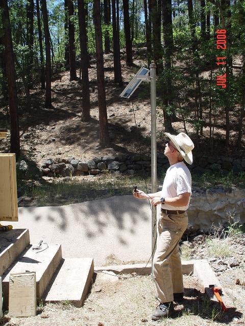 Hydrologist Boris Poff is verifying the azimuth of the newly added solar panel of Watershed 9. 
