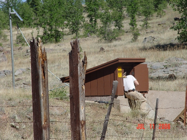 Hydrologist Boris Poff is accessing  the data logger of the Watershed 11 stream gauging station to download streamflow data of the 2006 monsoonal run-off.