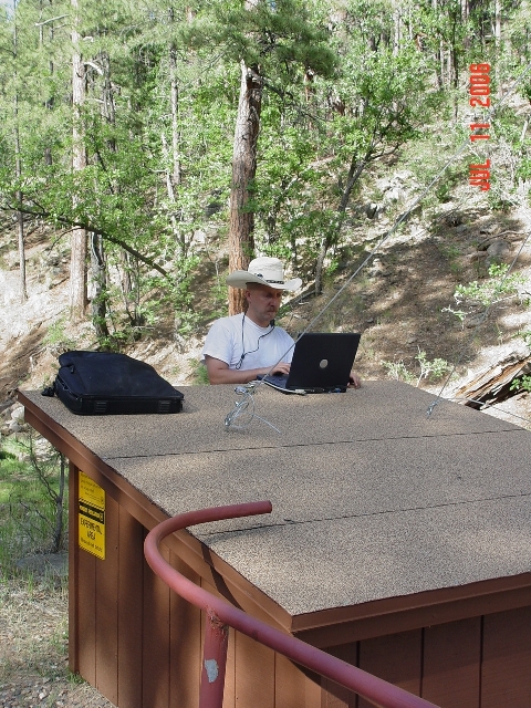 Hydrologist Boris Poff is accessing  the data logger of the Watershed 14 stream gauging station to download streamflow data of the 2006 monsoonal run-off.