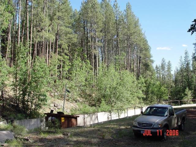 Hydrologist Boris Poff is accessing  the data logger of the Watershed 14 stream gauging station to download streamflow data of the 2006 monsoonal run-off.