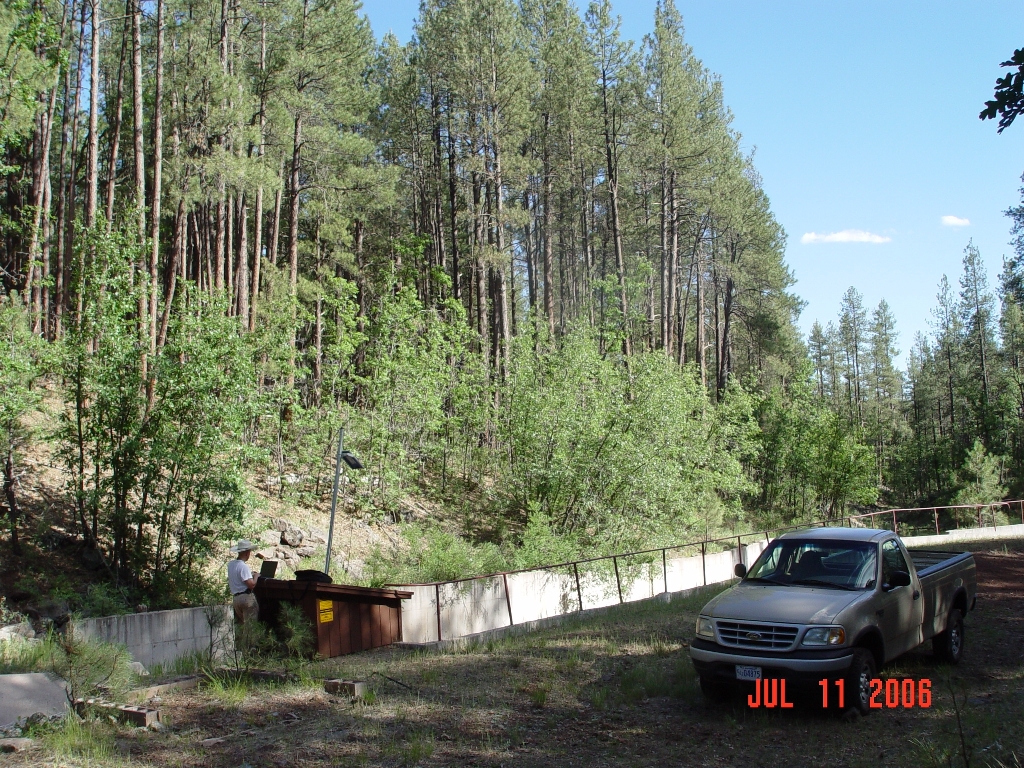 Hydrologist Boris Poff is accessing  the data logger of the Watershed 14 stream gauging station to download streamflow data of the 2006 monsoonal run-off.