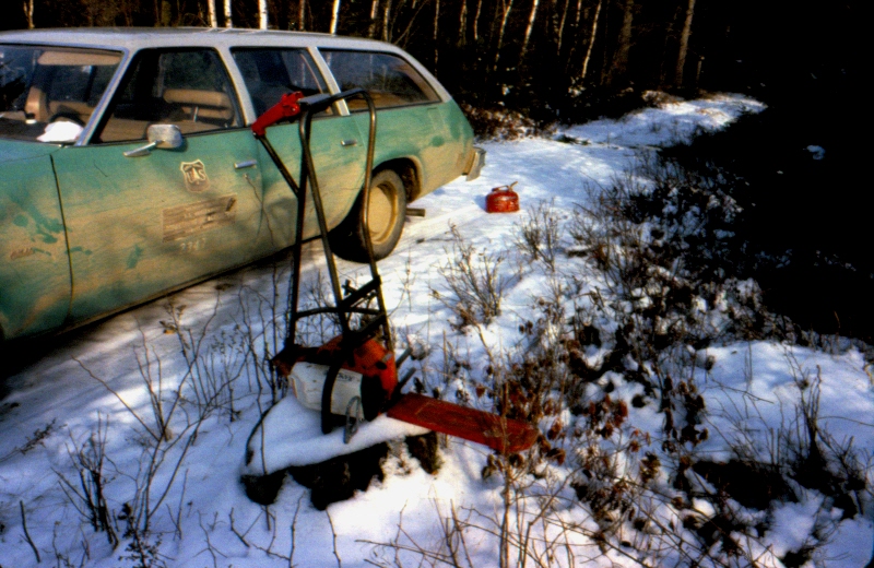 U.S. Forest Service vehicle on road, chainsaw, 1970s or 1980s