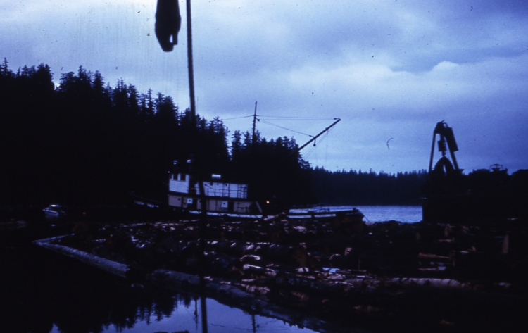 Side dumping ocean going log barge bundles go from Yakutat to Sitka