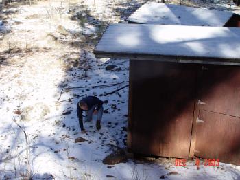 Duncan inspects the stream gauge shed of sub-watershed 87 during an assessment to reinstate a series of sub-watersheds.