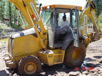Heavy machinery is used to repair damage to the Bar M stilling pond.