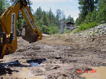 Heavy machinery is used to repair damage to the Bar M stilling pond.