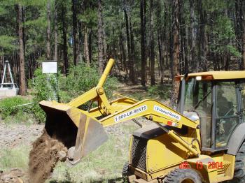 Heavy machinery is used to level the Woods Canyon stilling pond after years of streamflow had erroded the streambed.