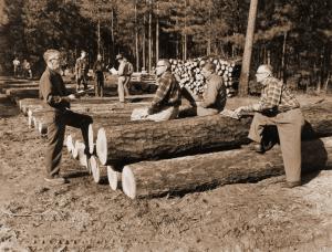 Russ Reynolds (on left) instructing landowners about the benefits of good forestry.  Annual harvest on Poor Farm Forty, Crossett Experimental Forest.