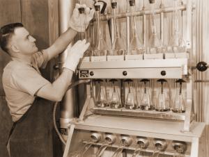 Unidentified staff member running leaf nitrogen content determinations on a kjeldahl apparatus.