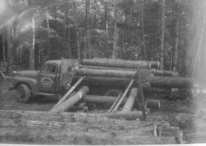 Hand loading of log truck from log yard along winter haul road, in MU5 in November 1952